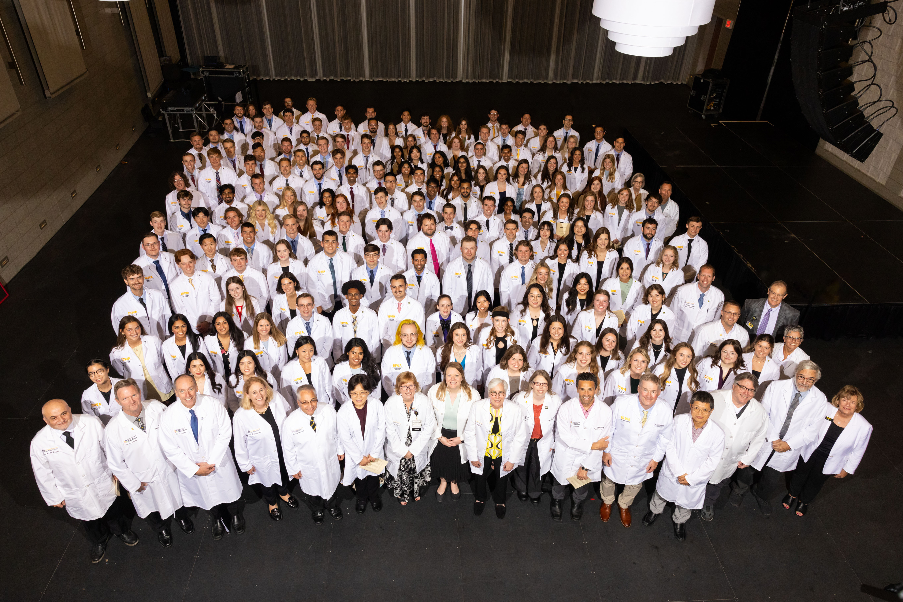 Carver College of Medicine first-year medical students receive their white coats during the White Coat Ceremony at Hancher Auditorium on Friday, Aug. 16, 2024.