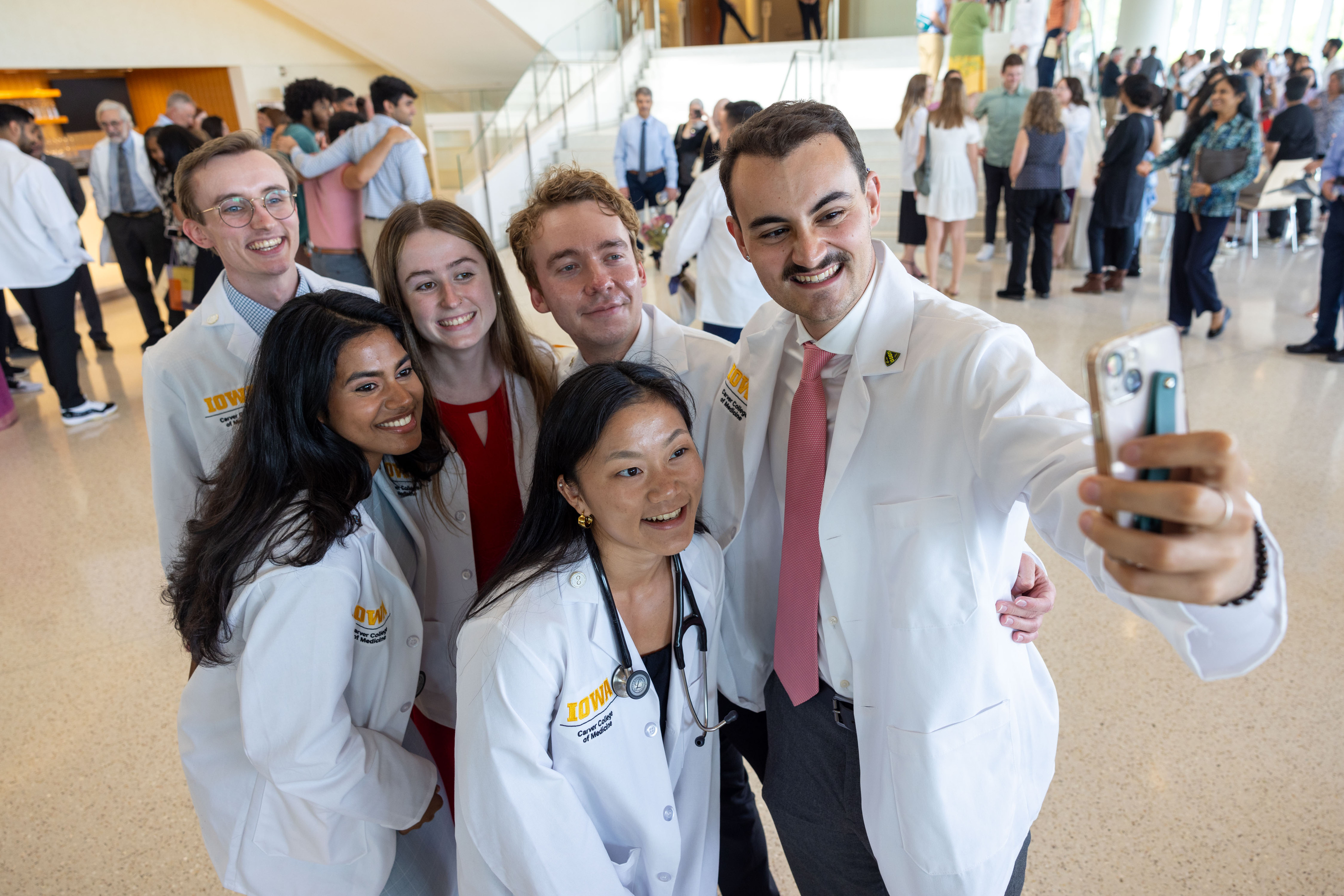 Carver College of Medicine first-year medical students receive their white coats during the White Coat Ceremony at Hancher Auditorium on Friday, Aug. 16, 2024.