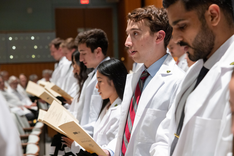 Carver College of Medicine first-year medical students receive their white coats during the White Coat Ceremony at Hancher Auditorium on Friday, Aug. 16, 2024.