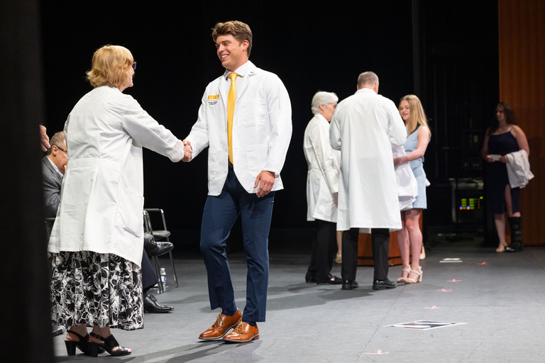 Carver College of Medicine first-year medical students receive their white coats during the White Coat Ceremony at Hancher Auditorium on Friday, Aug. 16, 2024.