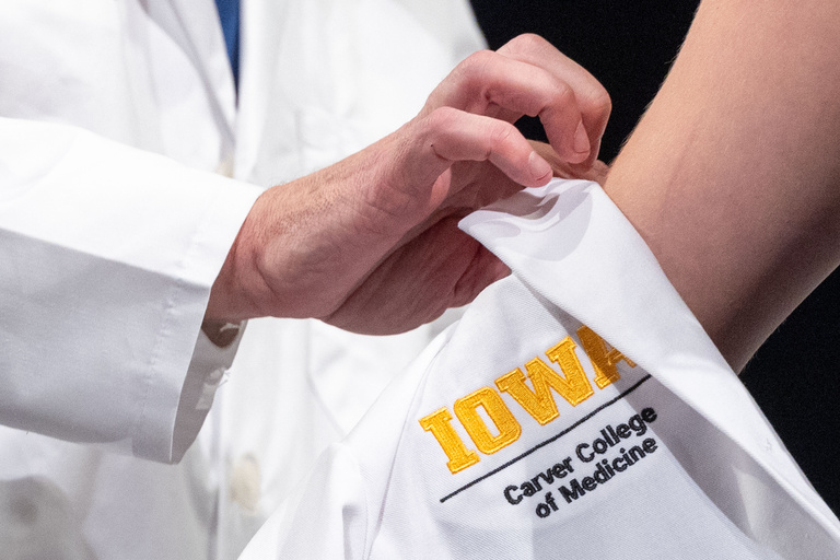 Carver College of Medicine first-year medical students receive their white coats during the White Coat Ceremony at Hancher Auditorium on Friday, Aug. 16, 2024.