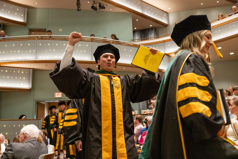 MD Commencement graduate celebrates during ceremony.