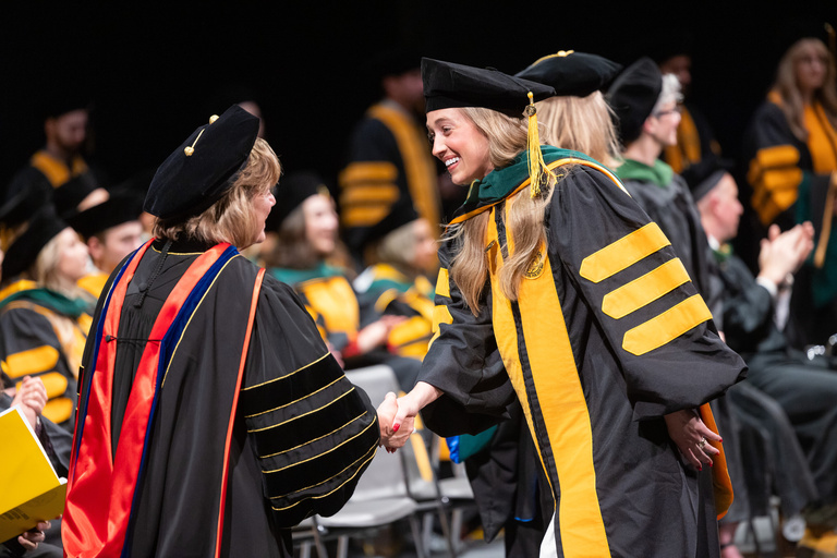 Bailey Jackson graduates at the MD commencement ceremony.
