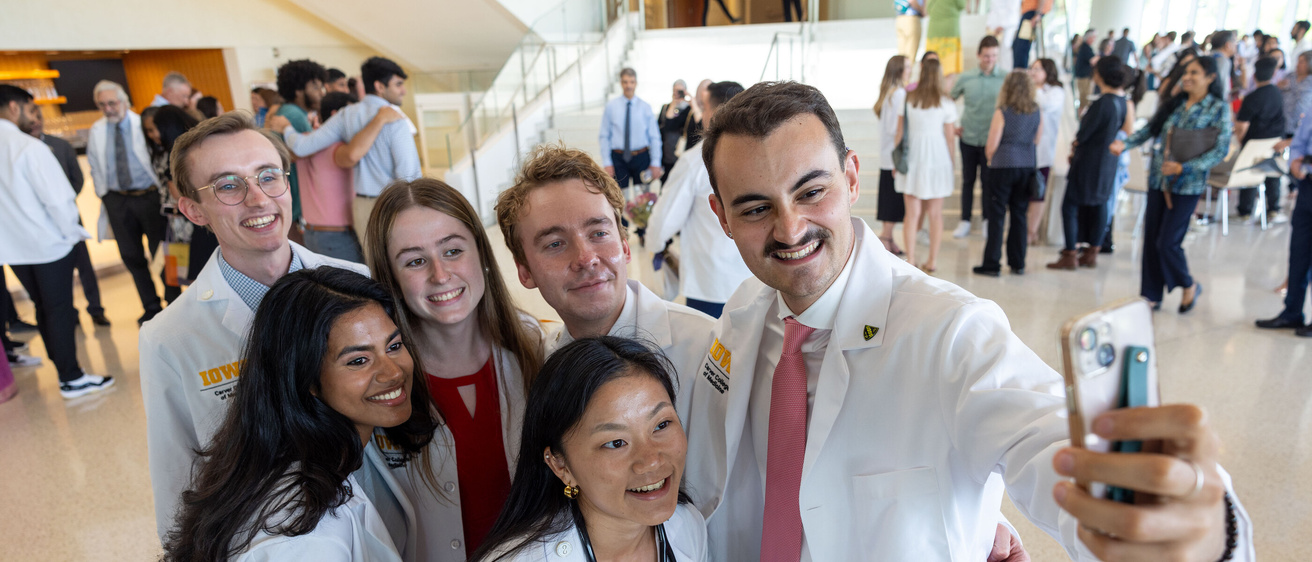 Carver College of Medicine first-year medical students receive their white coats during the White Coat Ceremony at Hancher Auditorium on Friday, Aug. 16, 2024.