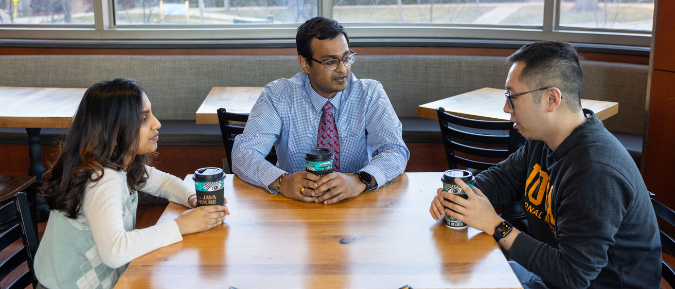 Fourth year medical student Vijay Kamalumpundi with his mentee, Ravina Vasanwala, and mentor, third-year Internal Medicine resident Jeremy Zhang, at Java House at Carver College of Medicine on Wednesday, Feb. 28, 2024.