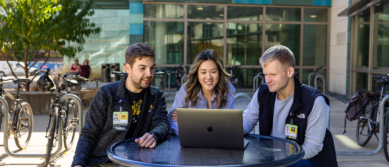 Medical students Michelle Chen, Harrison Parker, Spenser Larson on the Carver College of Medicine campus with fall foliage on Thursday, Oct. 24, 2024.